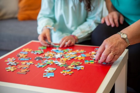 Putting together a Puzzle with Older Parents